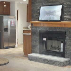 A photo of a gray slate fire place in a Vermont manufactured home available from Fecteau